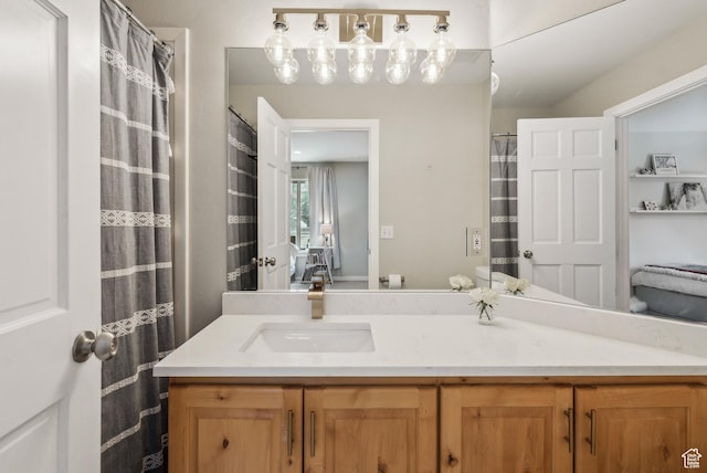 ensuite bathroom with vanity and connected bathroom