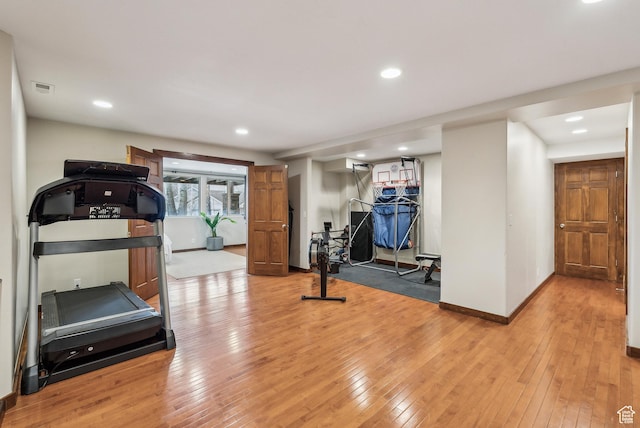 exercise room with baseboards, recessed lighting, visible vents, and light wood-type flooring