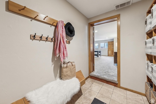 mudroom featuring visible vents, baseboards, and light tile patterned flooring