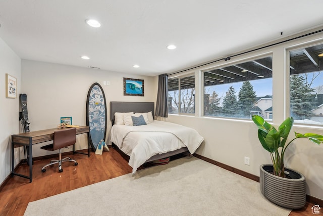 bedroom featuring wood finished floors, baseboards, and recessed lighting