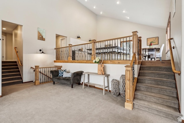stairway with recessed lighting, high vaulted ceiling, and carpet floors