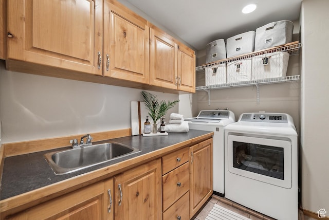 clothes washing area with light tile patterned flooring, washer and dryer, cabinet space, and a sink