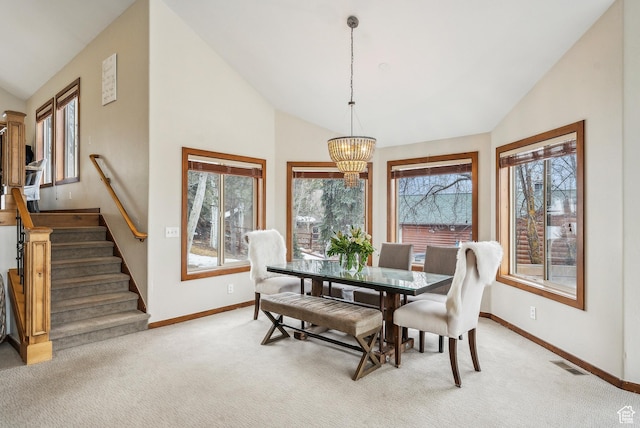 dining room with visible vents, vaulted ceiling, a chandelier, light carpet, and baseboards