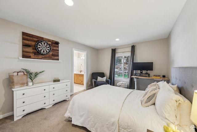 bedroom with ensuite bathroom, light carpet, baseboards, and recessed lighting