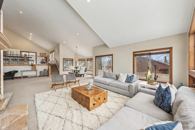 carpeted living area featuring recessed lighting, stairway, and high vaulted ceiling