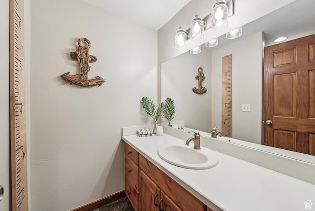 bathroom featuring baseboards and vanity
