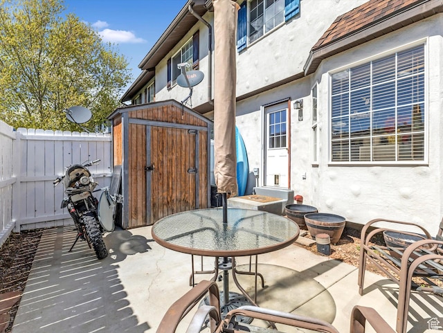 890 E Hamlet Cir N, Midway, UT 84049 - view of patio featuring an outdoor structure, a fenced backyard, and a storage unit