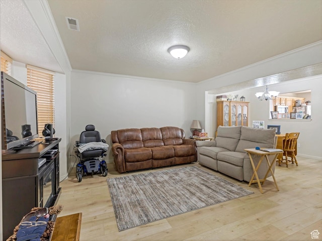 890 E Hamlet Cir N, Midway, UT 84049 - living area with an inviting chandelier, crown molding, light wood-type flooring, visible vents, and a textured ceiling