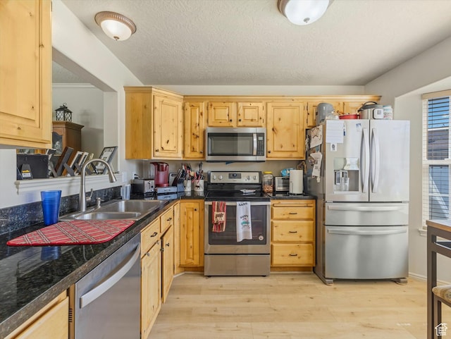 890 E Hamlet Cir N, Midway, UT 84049 - kitchen featuring a sink, dark countertops, light brown cabinets, light wood-type flooring, and appliances with stainless steel finishes