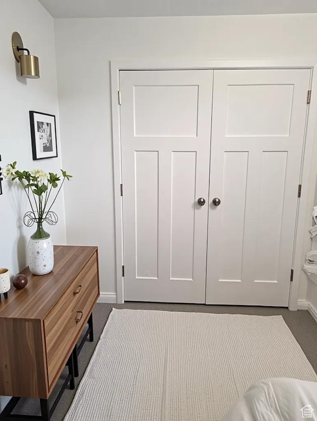 621 Shay Ln, Tooele, UT 84074 - doorway to outside featuring dark carpet and baseboards