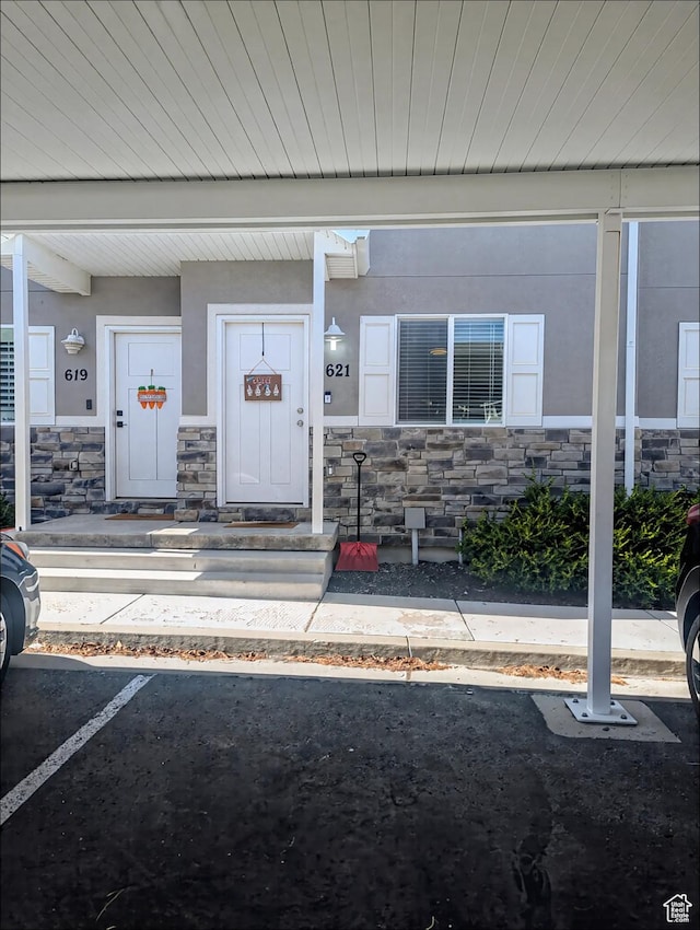 621 Shay Ln, Tooele, UT 84074 - view of exterior entry featuring stone siding and covered porch