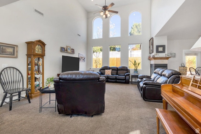 1056 W 100 N, St George, UT 84770 - living room with a ceiling fan, a high ceiling, visible vents, and carpet