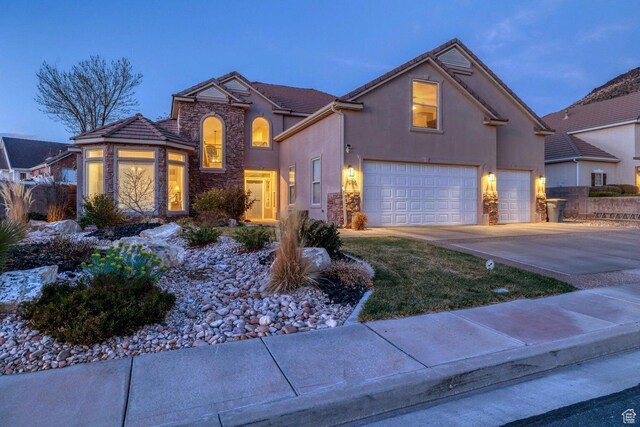 1056 W 100 N, St George, UT 84770 - traditional home featuring a garage, stucco siding, and stone siding