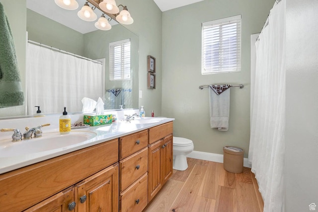 1056 W 100 N, St George, UT 84770 - full bath with toilet, double vanity, a sink, and wood finished floors