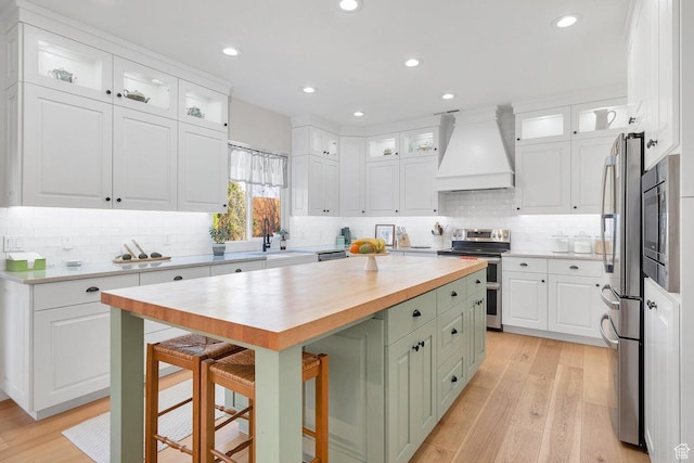 1056 W 100 N, St George, UT 84770 - kitchen with white cabinetry, wooden counters, custom range hood, and appliances with stainless steel finishes