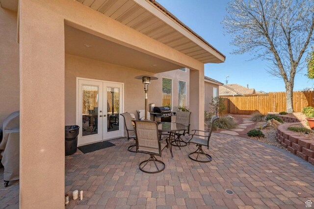 1056 W 100 N, St George, UT 84770 - view of patio featuring outdoor dining space, grilling area, fence, and french doors