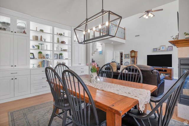 1056 W 100 N, St George, UT 84770 - dining space with visible vents, light wood-style flooring, ceiling fan, and a towering ceiling