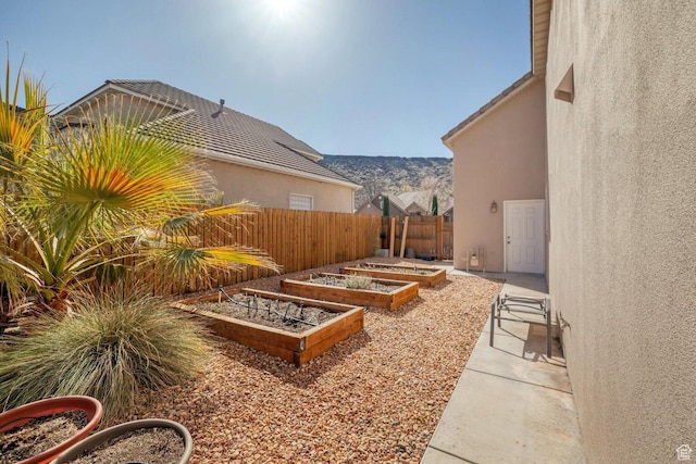 1056 W 100 N, St George, UT 84770 - view of yard with a mountain view, a garden, and fence