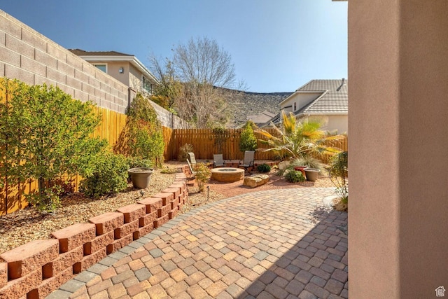 1056 W 100 N, St George, UT 84770 - view of patio / terrace featuring a fenced backyard and a fire pit