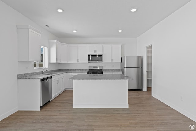 kitchen featuring recessed lighting, white cabinets, appliances with stainless steel finishes, and a sink