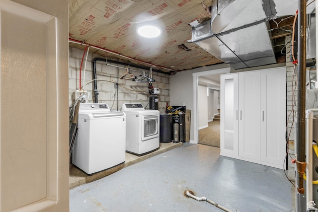 unfinished basement with washing machine and clothes dryer