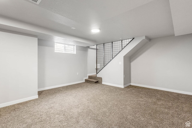 below grade area with baseboards, stairway, and carpet floors