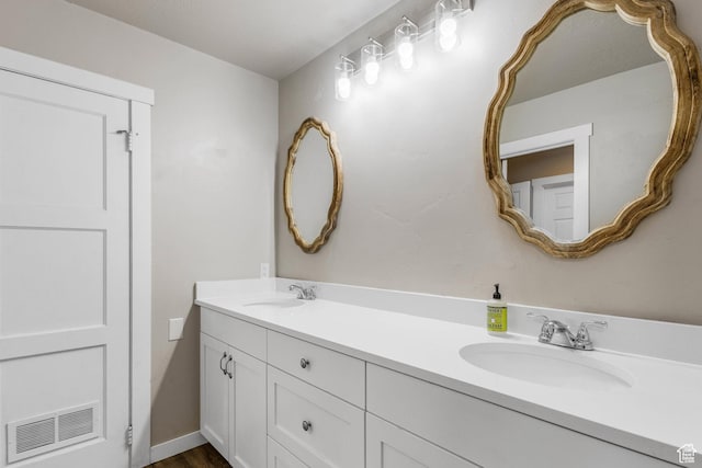bathroom featuring a sink, double vanity, and visible vents