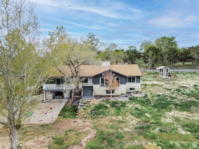rear view of property with stairs