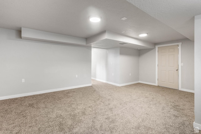 finished below grade area featuring baseboards and carpet flooring