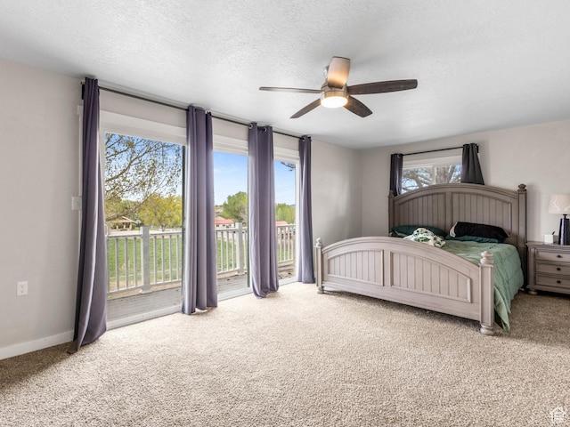 bedroom featuring carpet, a textured ceiling, baseboards, ceiling fan, and access to outside