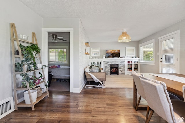 1923 S 600 E, Salt Lake City, UT 84105 - dining space with wood finished floors, visible vents, a fireplace, ceiling fan, and baseboards