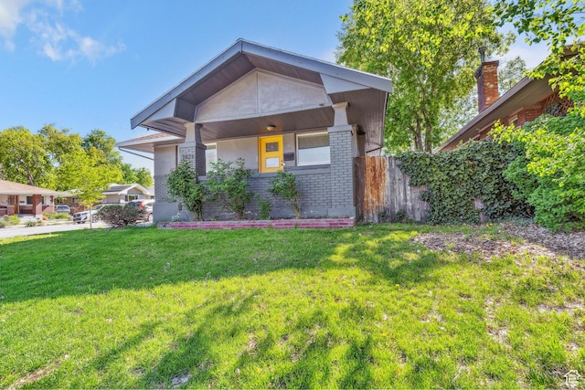 1923 S 600 E, Salt Lake City, UT 84105 - view of front facade featuring a front lawn, brick siding, and fence