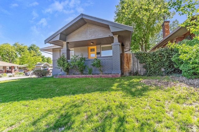 1923 S 600 E, Salt Lake City, UT 84105 - view of front of home featuring a front lawn, brick siding, and fence