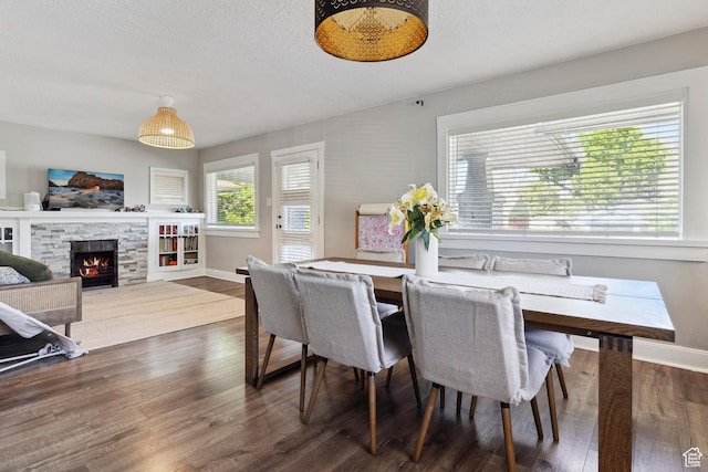 1923 S 600 E, Salt Lake City, UT 84105 - dining space featuring a fireplace, baseboards, and wood finished floors