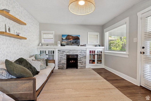 1923 S 600 E, Salt Lake City, UT 84105 - living area featuring baseboards, a stone fireplace, a healthy amount of sunlight, and wood finished floors
