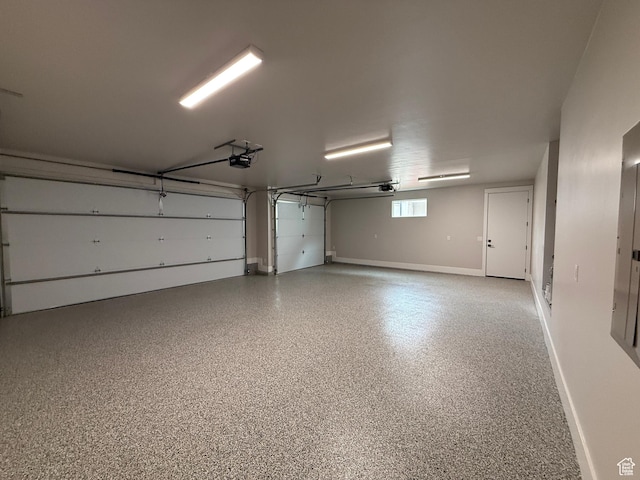 garage with baseboards and a garage door opener