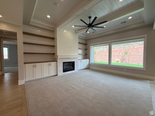 unfurnished living room featuring baseboards, a glass covered fireplace, and visible vents