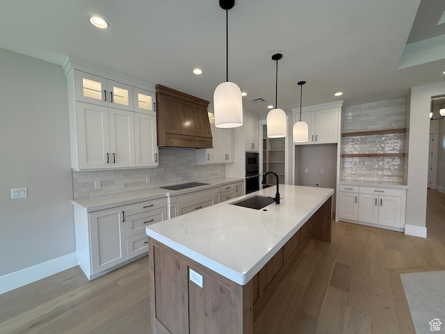 kitchen with recessed lighting, baseboards, custom range hood, backsplash, and light wood-style floors