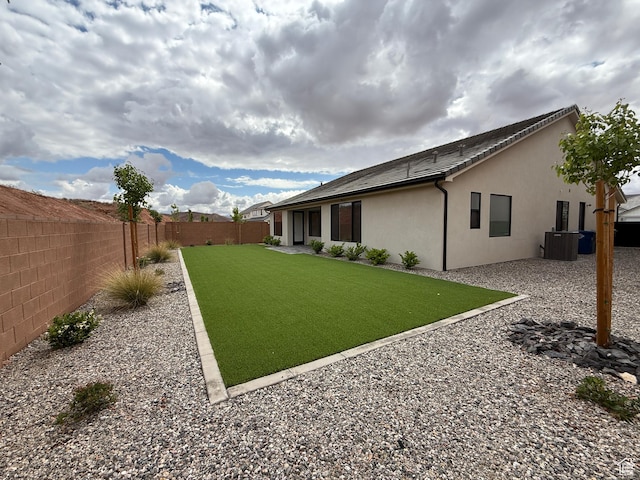 view of yard featuring a fenced backyard and central AC unit