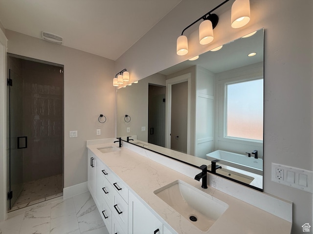 full bath featuring a sink, a stall shower, marble finish floor, and a freestanding tub