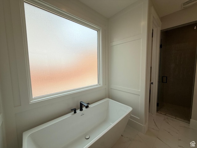 bathroom featuring a freestanding bath, visible vents, marble finish floor, and a stall shower