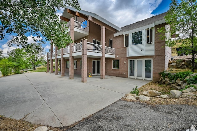 320 S Old Farm Ln E, Coalville, UT 84017 - back of property featuring roof with shingles, a patio, and brick siding