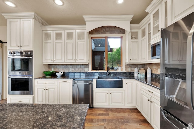 320 S Old Farm Ln E, Coalville, UT 84017 - kitchen featuring a sink, crown molding, wood finished floors, tasteful backsplash, and appliances with stainless steel finishes