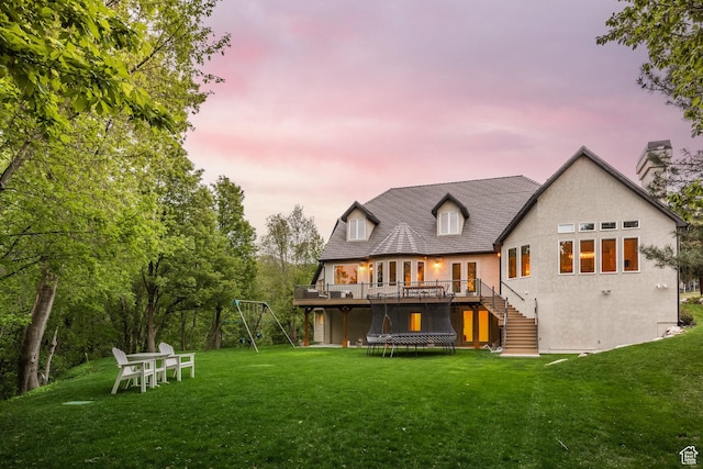 680 S Davis Blvd, Bountiful, UT 84010 - back of property at dusk with a lawn, a chimney, french doors, stairs, and a wooden deck