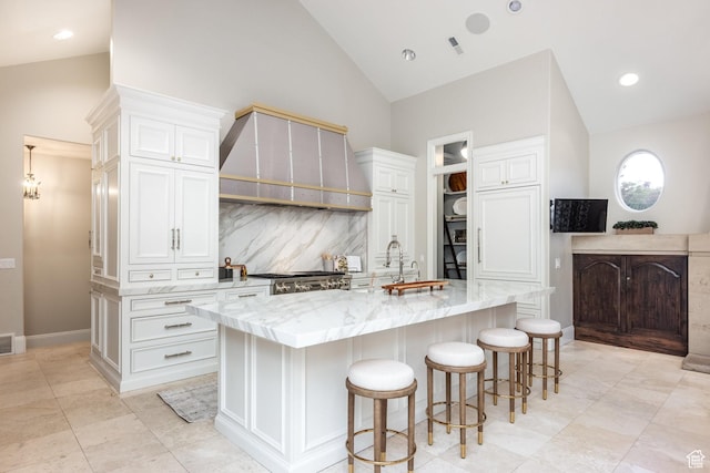 680 S Davis Blvd, Bountiful, UT 84010 - kitchen featuring backsplash, light stone counters, custom range hood, and white cabinets