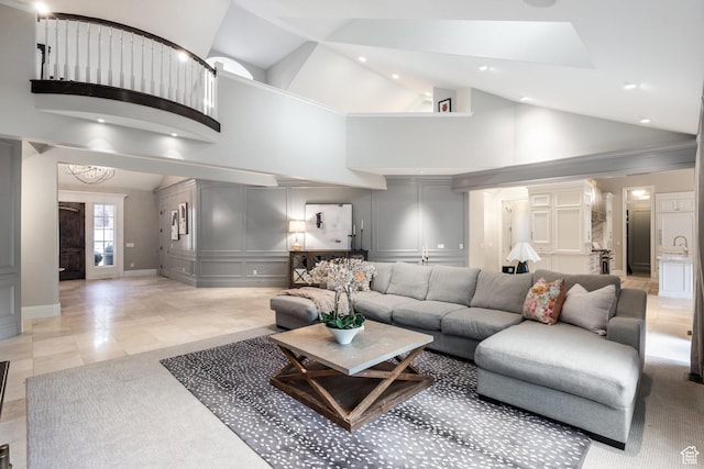 680 S Davis Blvd, Bountiful, UT 84010 - living area with recessed lighting, baseboards, light tile patterned floors, a decorative wall, and high vaulted ceiling