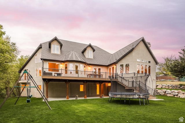 680 S Davis Blvd, Bountiful, UT 84010 - rear view of house featuring stairs, a yard, stucco siding, a wooden deck, and a playground