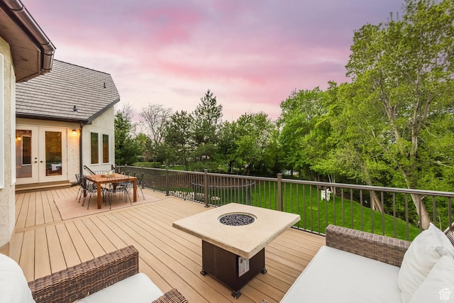 680 S Davis Blvd, Bountiful, UT 84010 - deck at dusk featuring a yard, french doors, an outdoor living space with a fire pit, and outdoor dining area