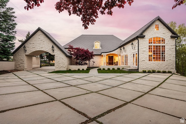 view of front of property featuring a high end roof and stone siding