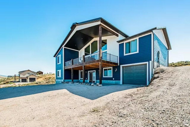 2869 S Chukar Dr Unit 63, Garden City, UT 84028 - rear view of house with a balcony, a garage, and driveway